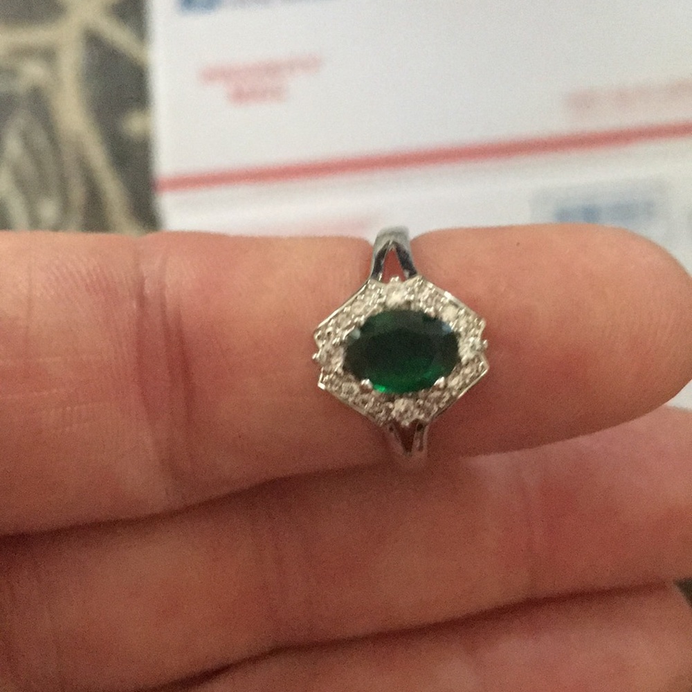 Silver band ring with a green stone